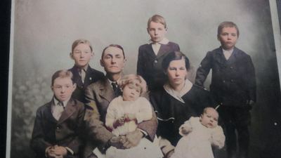 Restored and colorized (AI-assisted) — James David Coffman, JD Coffman family studio portrait, ~1915