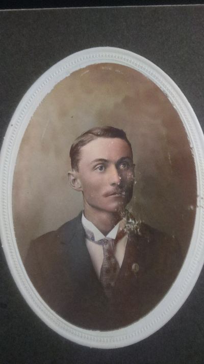 Restored and colorized (AI-assisted) — James David Coffman, JD Coffman oval cabinet portrait, young man ~1900