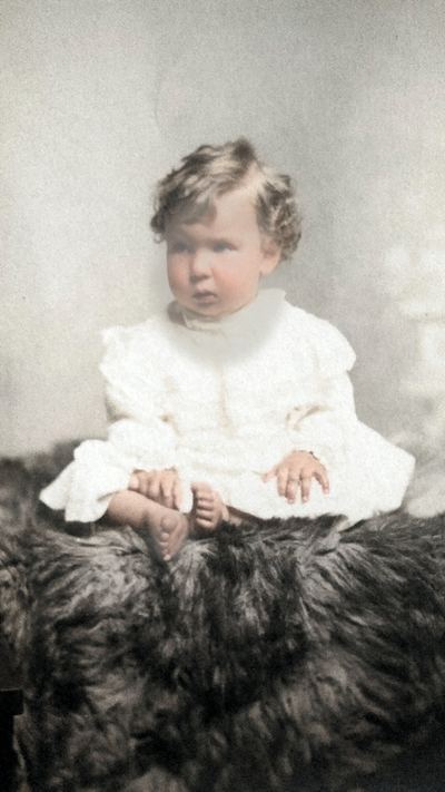 Restored and colorized (AI-assisted); faces are the original photo, colours are a best guess. Horace Glenn Coffman as a baby, c. 1915-16.