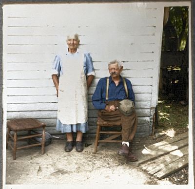 Restored and colorized (AI-assisted); faces are the original photo, colours are a best guess. Julia (Lone) and Mons Selland at their farmhouse.