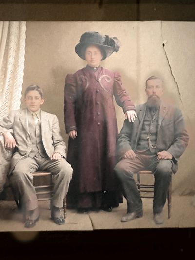 Restored and colorized (AI-assisted); faces are the original photo, colours are a best guess. Studio portrait — the Silva family, c. 1908–1912.